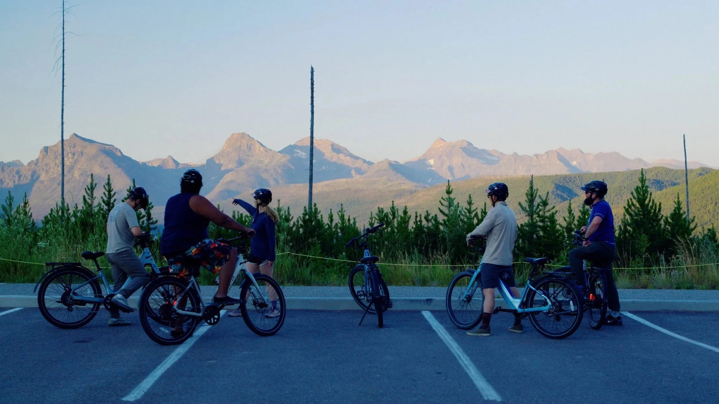 A group with e-bikes on Camas Road with the mountains behind
