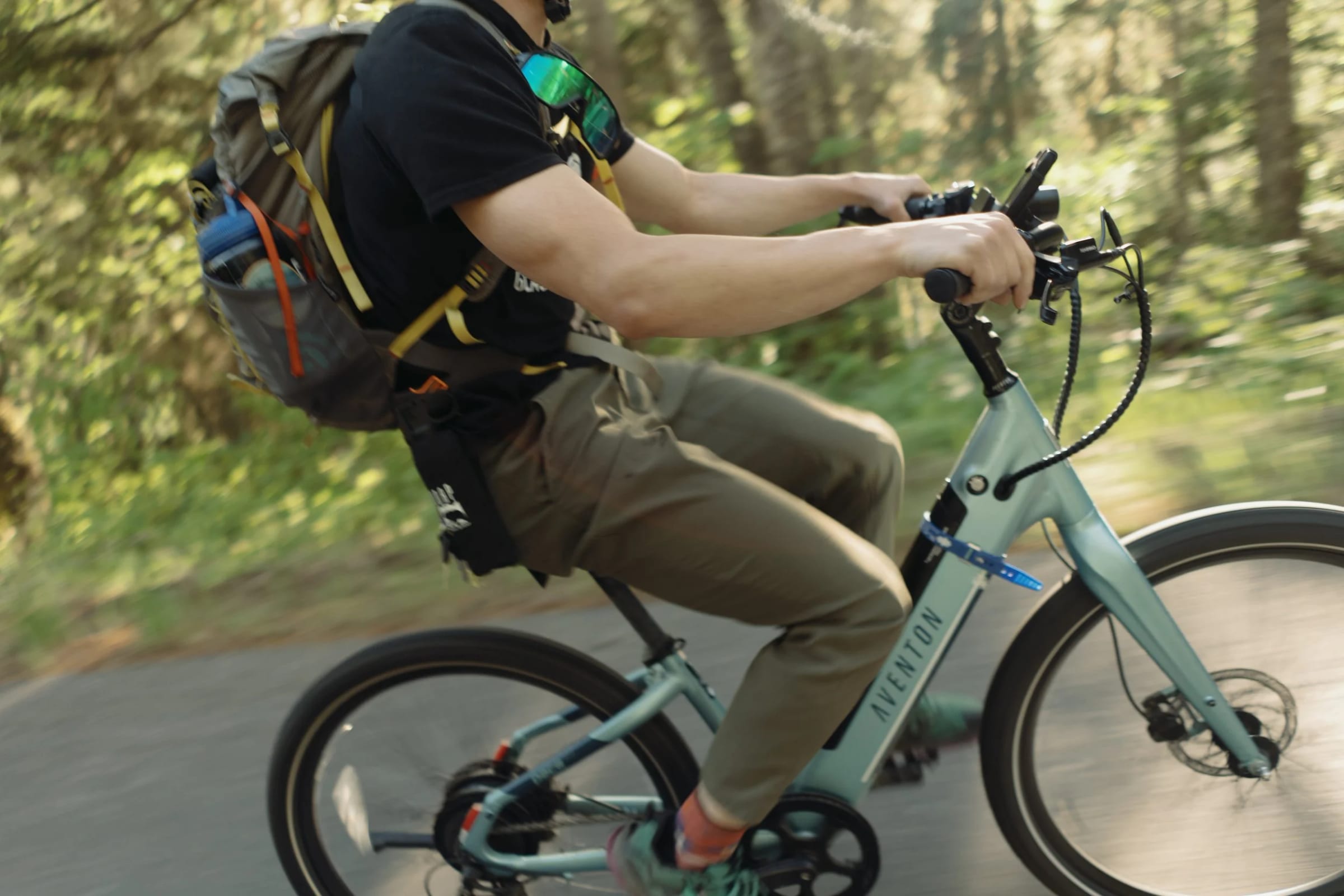 A guest riding an e-bike up a mountain road