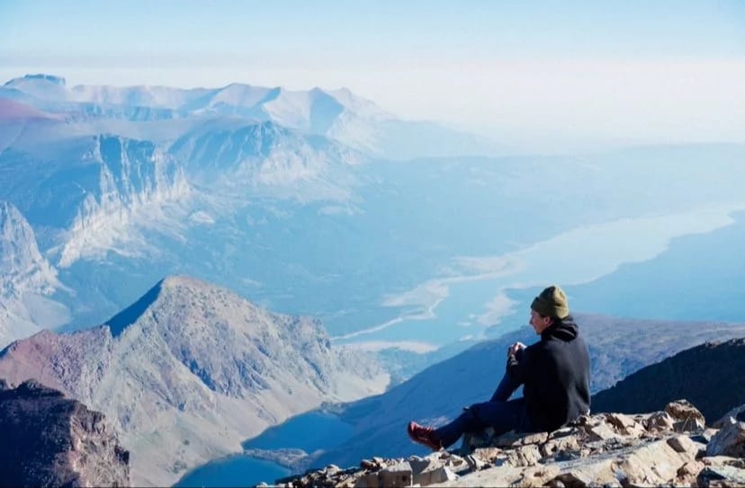 A hiker on a mountainside in Many Glacier