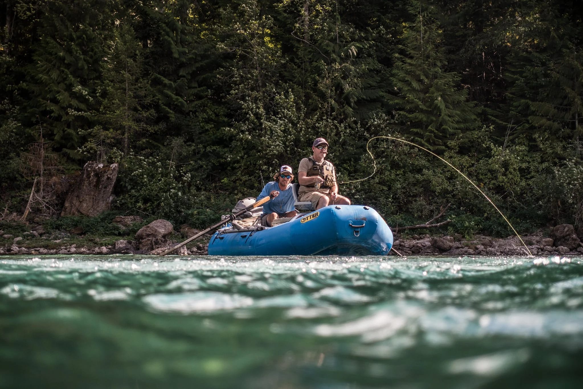 Paddlers in a raft on a bright river