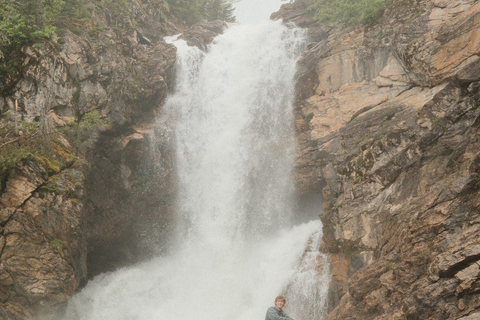 A waterfall pouring down a cliff in Glacier National Park