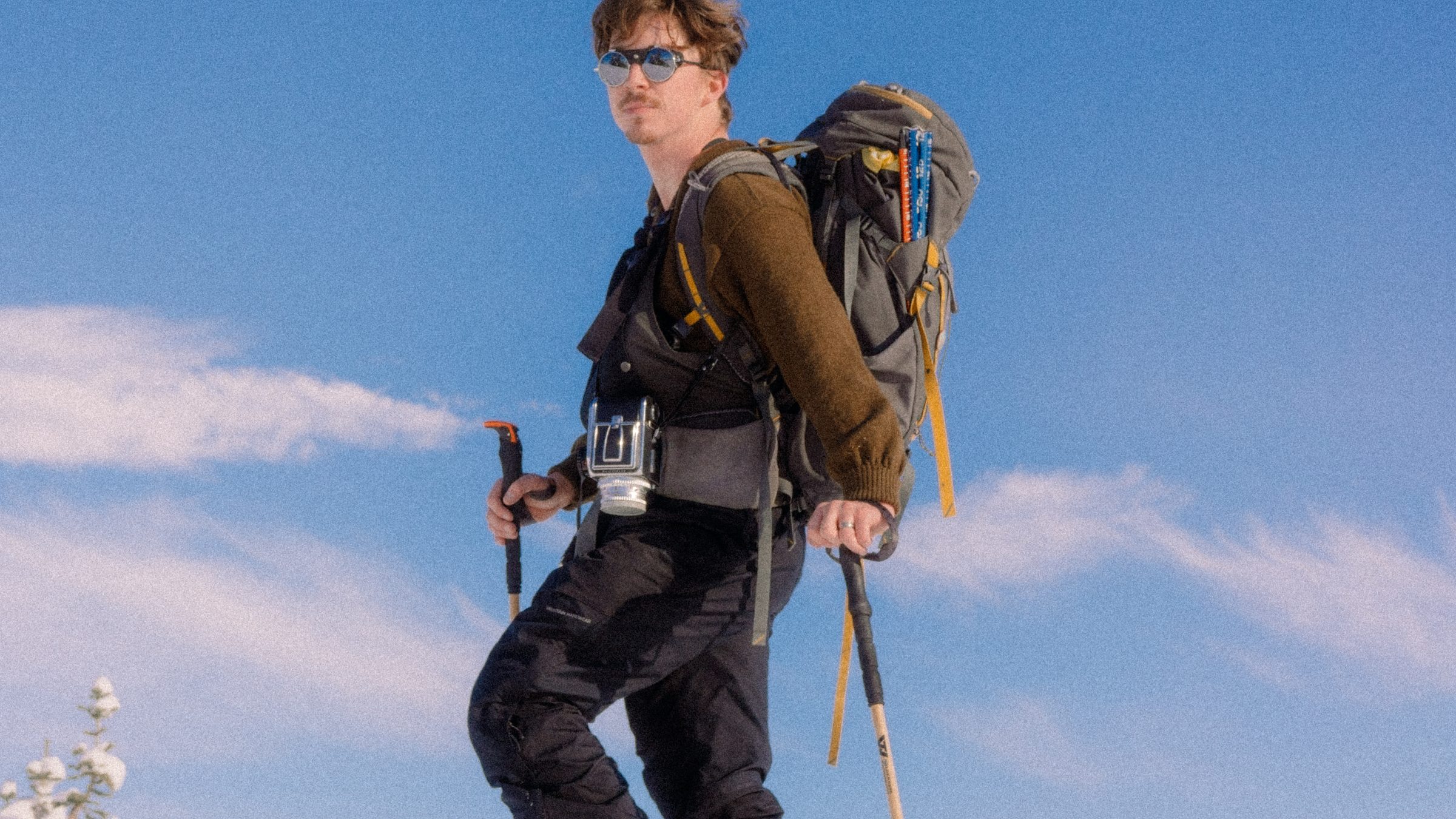 A snowshoer above the clouds on a bright winter day